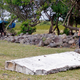 French police officers look over a piece of debris from a plane in Saint-Andre, Reunion Island, July 29, 2015. (Image: AP)